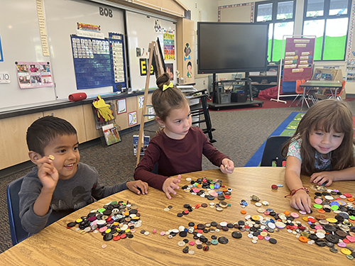 Group of Mrs. Thomason’s TK students working on a button activity