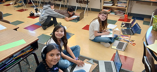 Group of student working on their laptops in the classroom