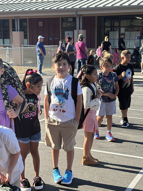 Happy students in a line outside on the first day of school