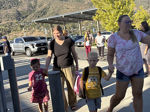 Parents walking their students to school
