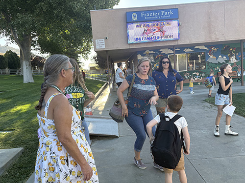 Parents and student outside campus on first day of school