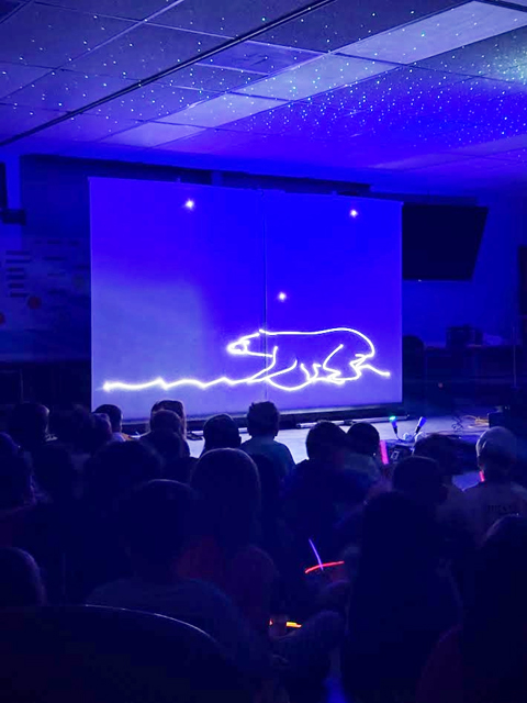 Students enjoying assembly presented by Prismatic Laser