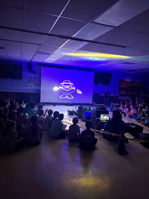 Students enjoying assembly presented by Prismatic Laser