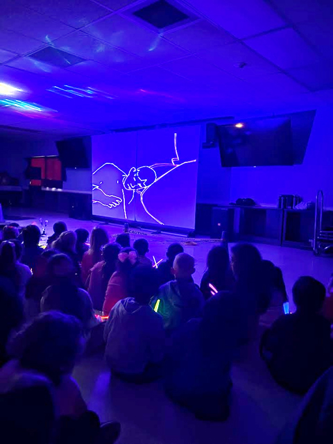 Students enjoying assembly presented by Prismatic Laser