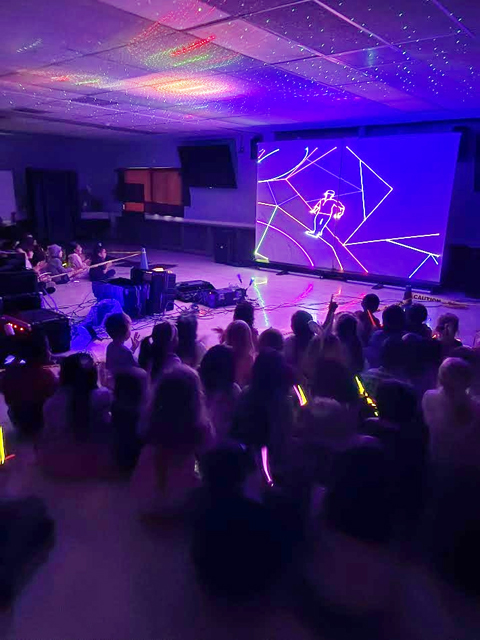 Students enjoying assembly presented by Prismatic Laser