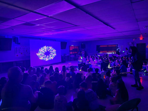 Students enjoying assembly presented by Prismatic Laser