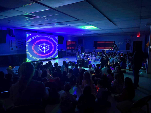 Students enjoying assembly presented by Prismatic Laser