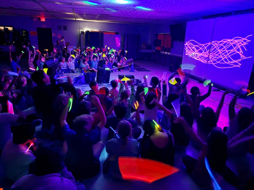 Students enjoying assembly presented by Prismatic Laser