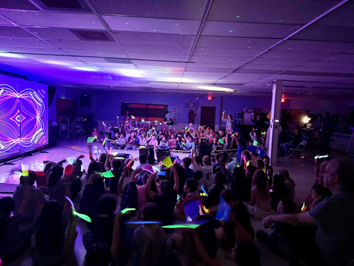 Students enjoying assembly presented by Prismatic Laser