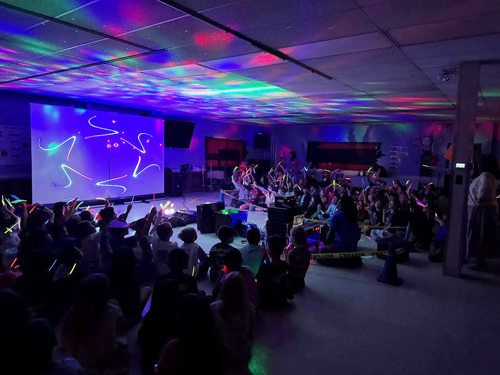 Students enjoying assembly presented by Prismatic Laser