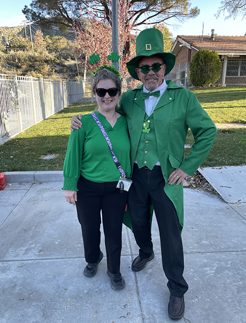 Principal McNelis dressed as a leprechaun with a staff member