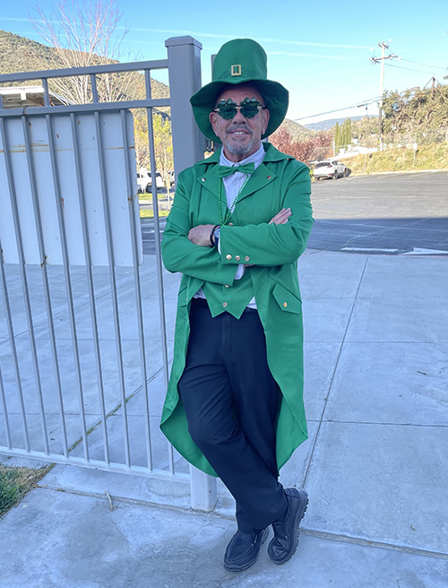 Principal McNelis dressed as a leprechaun at the front gate