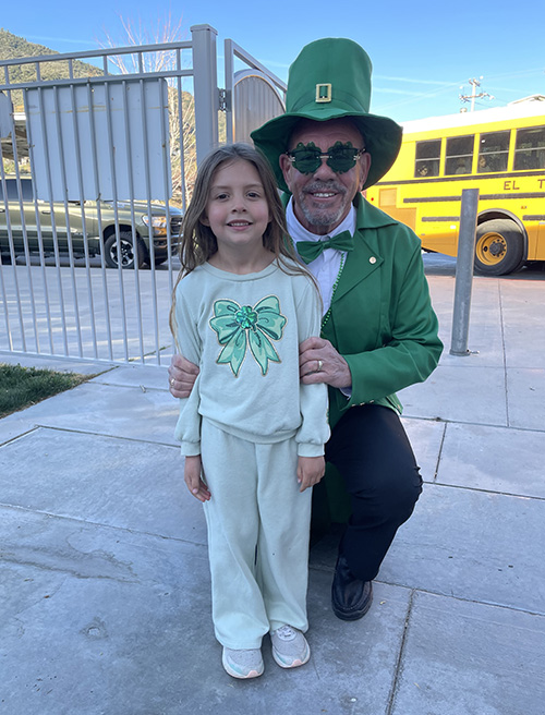 Principal McNelis dressed as a leprechaun with a student