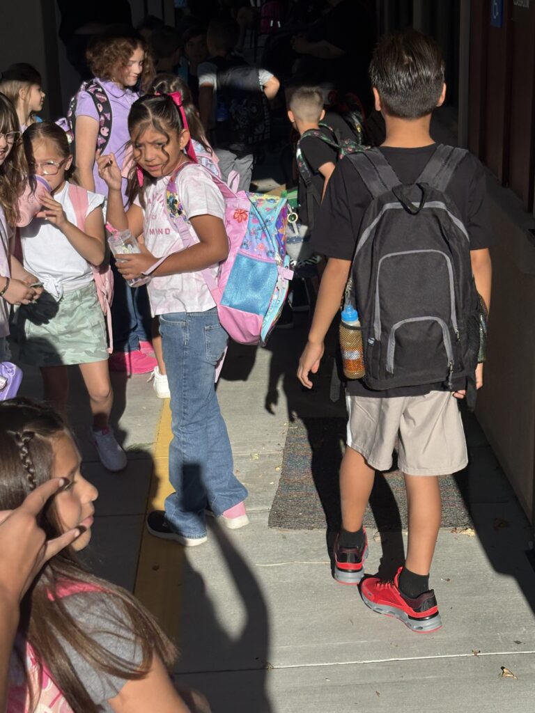 Group of students arriving to school with their backpacks