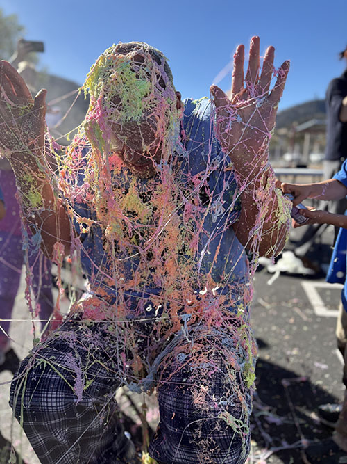 Principal drenched in Silly String outside