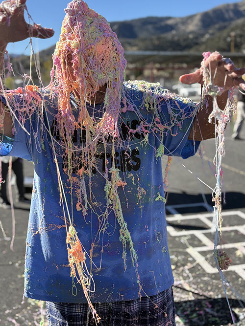 Close up of principal drenched in Silly String