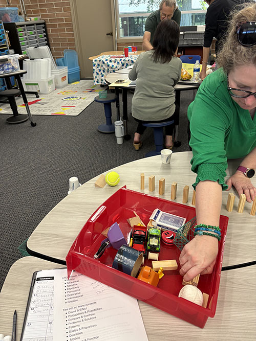 Teacher in green participating in a STEAM training event