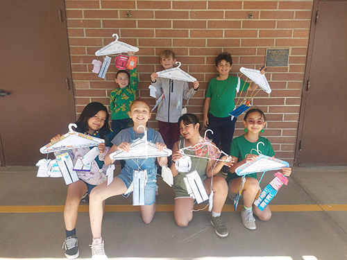Group of students holding up their final projects