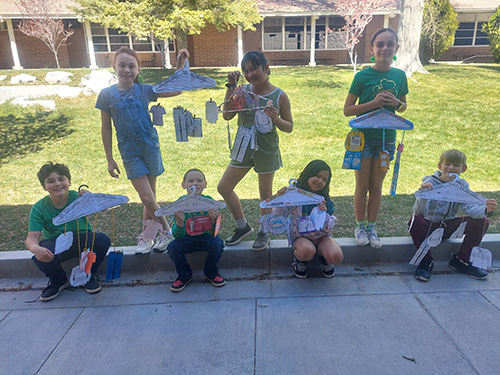 Fourth grade students posing for a picture with their projects