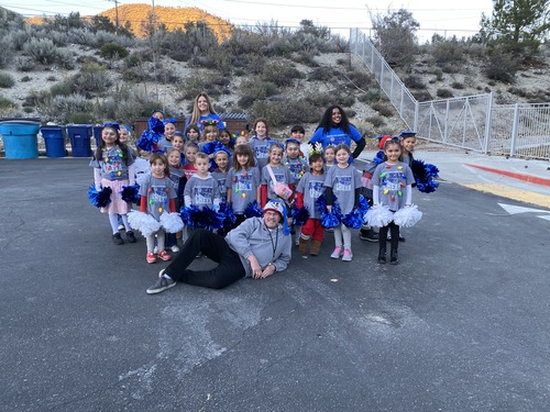 Group photo of student elves with teachers and principal