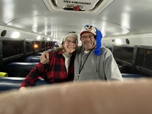 Principal and woman on the bus posing for a picture
