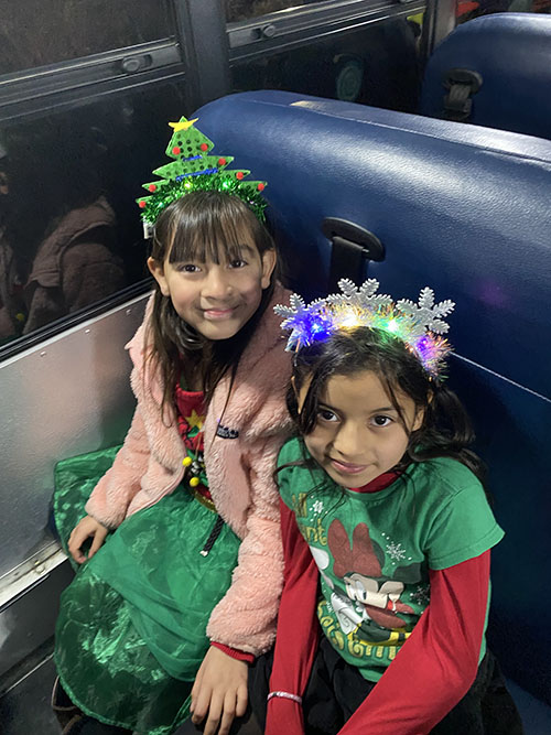 Two spirited student elves on the bus