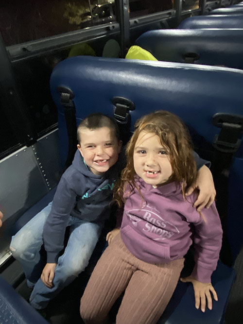 Two students sitting together on a bus