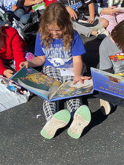 student sitting reading a book