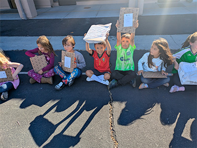 students showing their new books