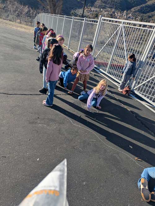 Students examining outlined shadows