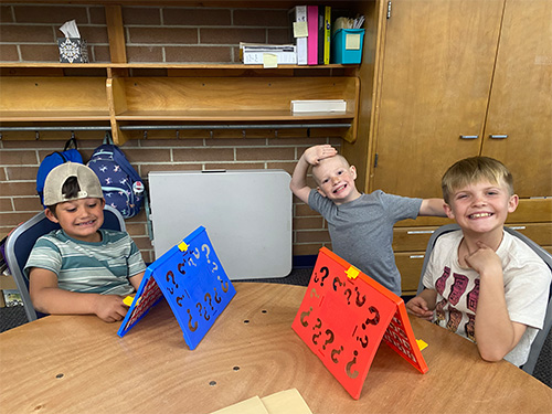 Students playing Guess Who