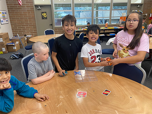 Students playing Uno card game