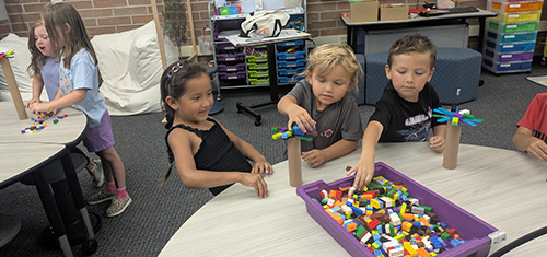 Students building Lego creations together