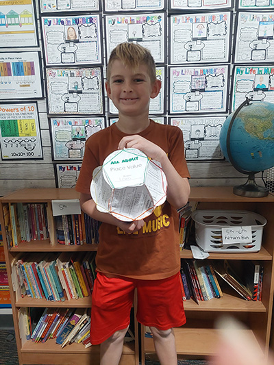 Boy holding large paper bloom project