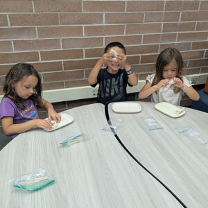 Students engaged in a clay art activity together