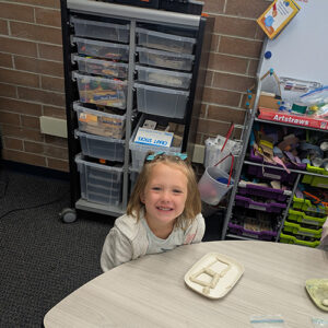 Student showing their clay creation