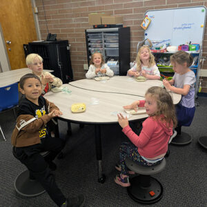 Children engaged in hands-on clay craft at school