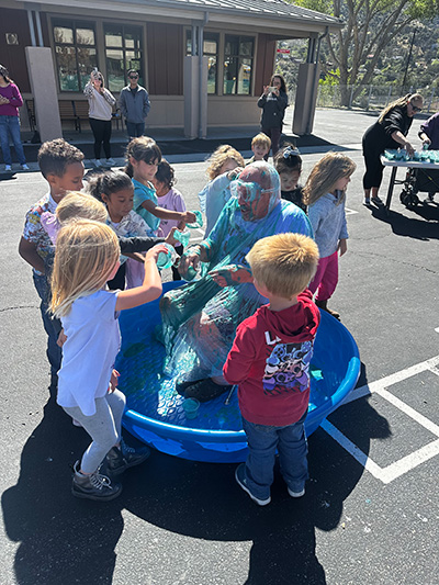 Students pouring slime on Principal McNelis