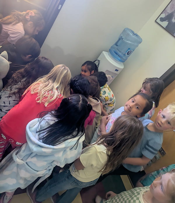 Students gathers around to see baby chicks