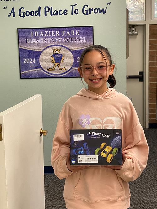 Student holding a stunt car kit
