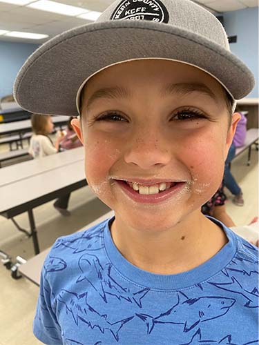 Student with messy donut face