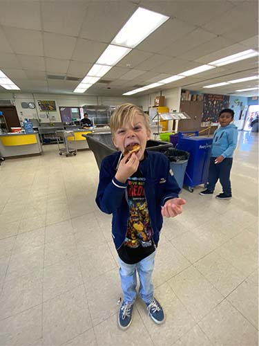 student eating a donut