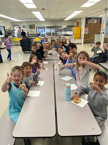 Students giving thumbs up