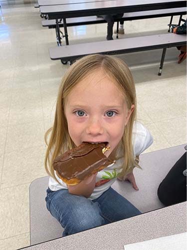 female student eating donut