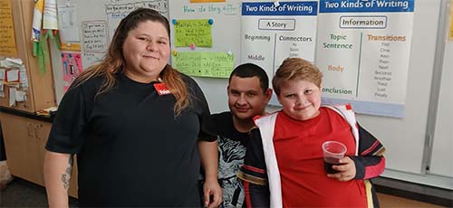 Two staff members with a student