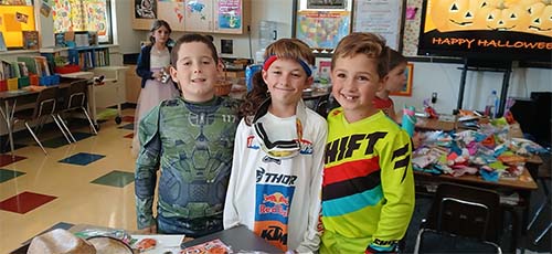 Three male students in costume