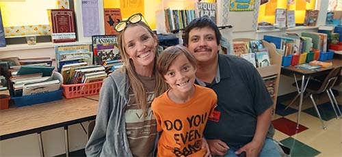 Two parents with a student