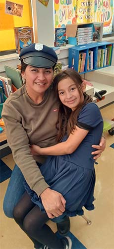 Staff and student hugging