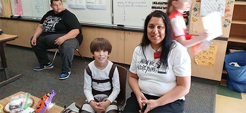 Staff member with student in costume