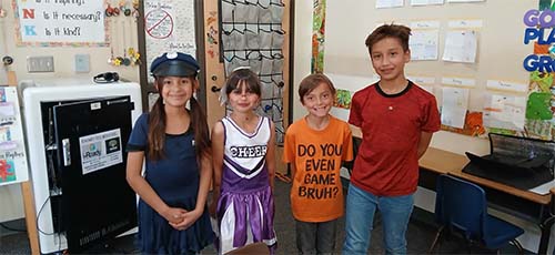 Four students in costumes